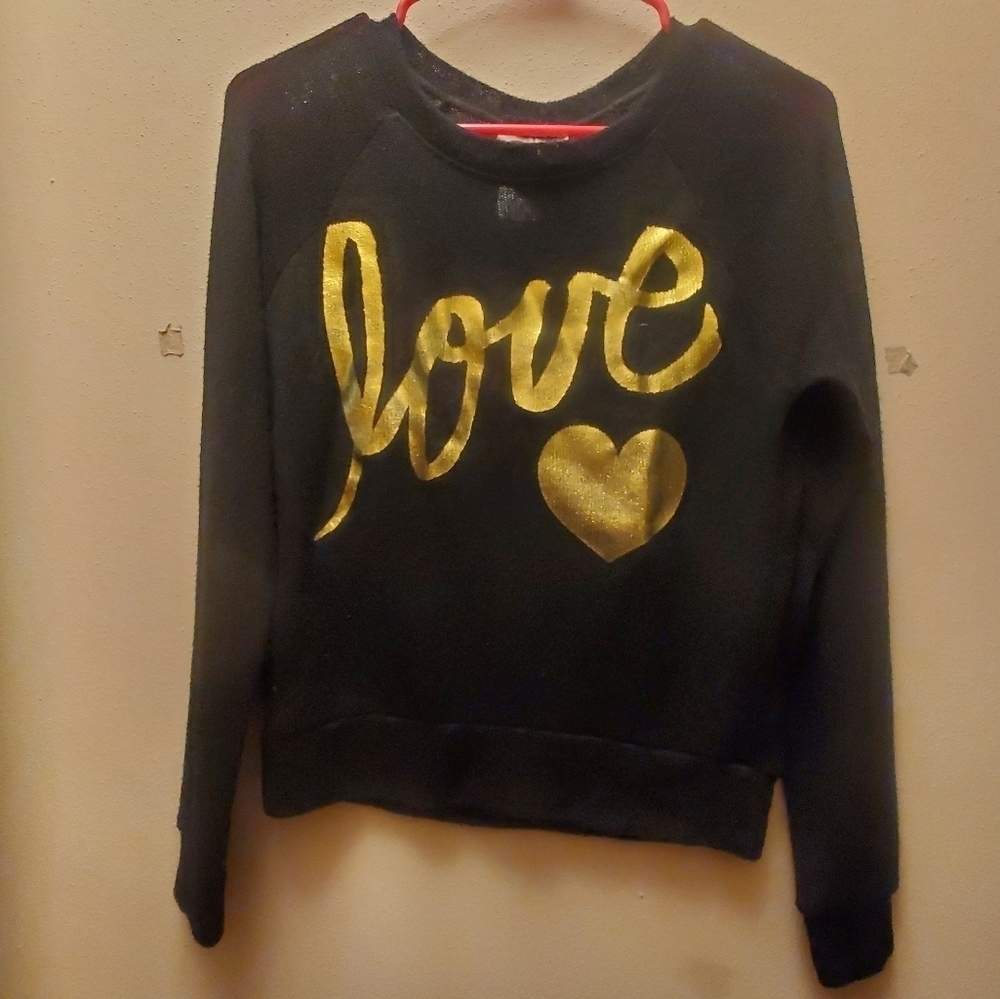 This is a junior's extra small black top with gold writing that says love